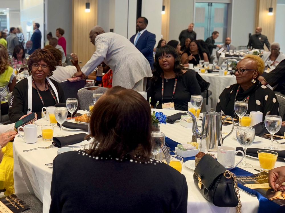 Guests sit around a table at the National Bar Association 100 year celebration. 
