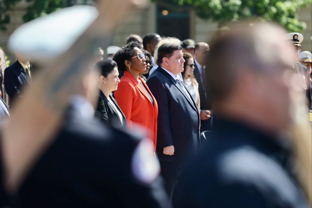 Lt. Governor Juliana Stratton, Governor Pritzker and Comptroller Mendoza stand together at a police ceremony.