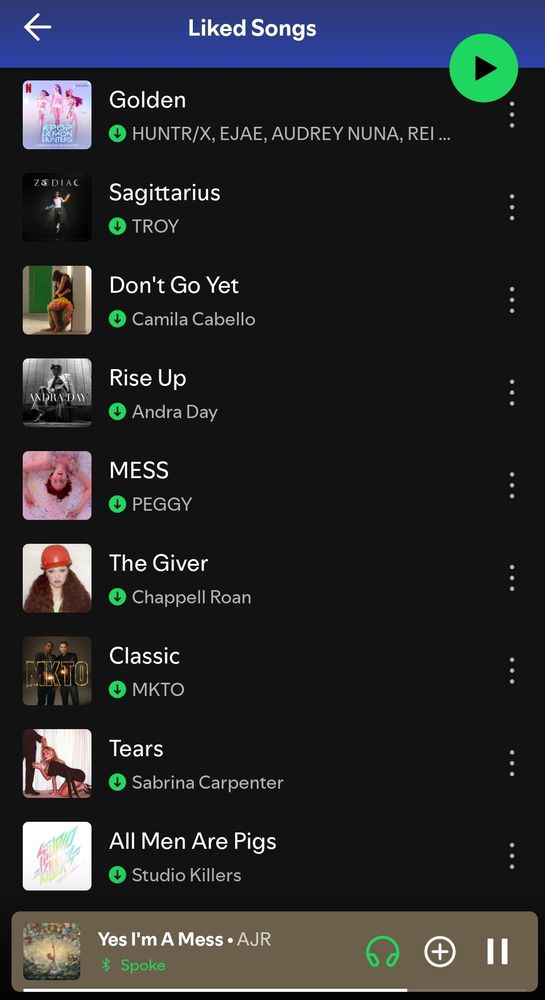 A screenshot of our Spotify liked songs listed: Golden by Huntr/x, Sagittarius by Troy, Don't Go Yet by Camila Cabello, Rise up by Andra Day, Mess by Peggy, The Giver by Chapell Roan, Classic by MKTO, Tears by Sabrina Carpenter, All Men Are Pigs by Studio Killers, with Yes I'm A Mess by AJR playing.
