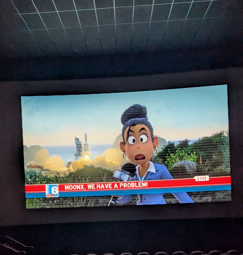 A picture of the DreamWorks animated film the Bad Guys 2, where a reporter in the movie is reporting on MoonX, a direct parody of SpaceX 