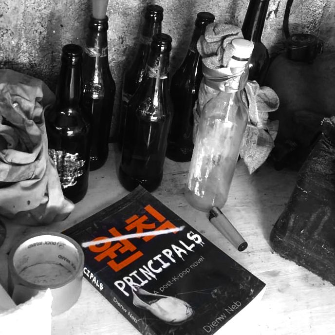 A copy of the book is shown resting on a table in black and white with the hangul word 원칙 highlighted in orange and crossed out in white spray-paint. Around the book are various empty bottles, rags, fuel cannisters and a lighter.