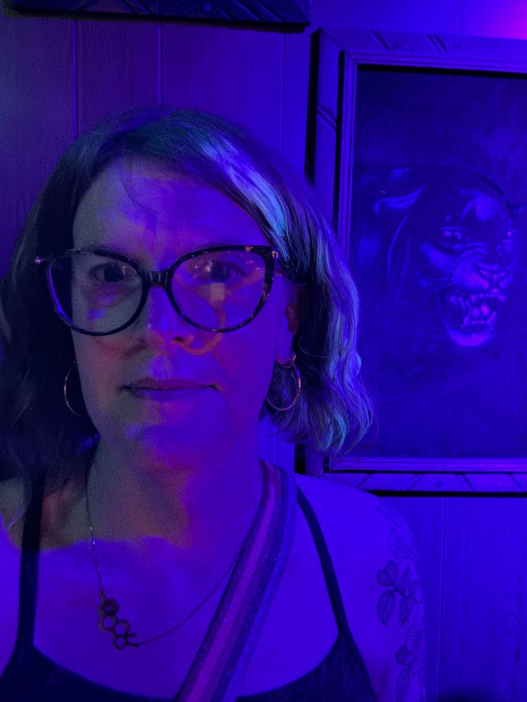 it’s jamie in front of a black light painting of a panther 