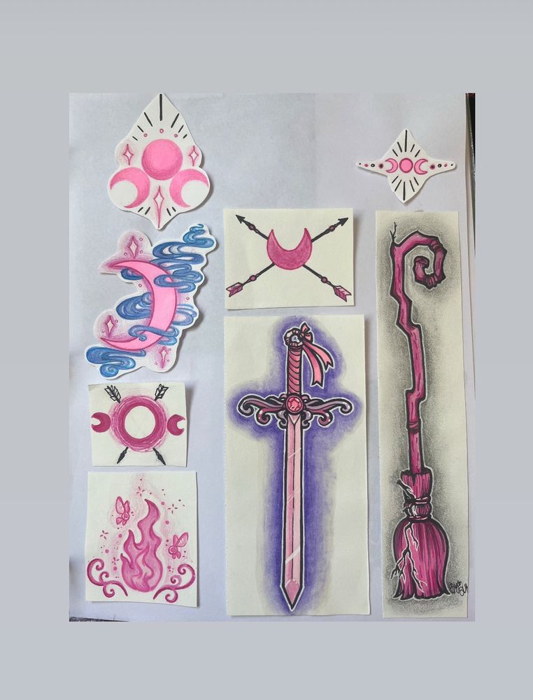 A collection of small drawings. A pink triple moon with lines, a pink crescent moon surrounded by blue magic energy, a triple moon with two black arrows, faerie fire, a crescent moon with two black arrows, a magical sword, a tiny triple moon, and a pink witches broom. 