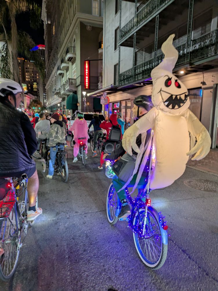 Group of bikes, one with an inflatable ghost on the back