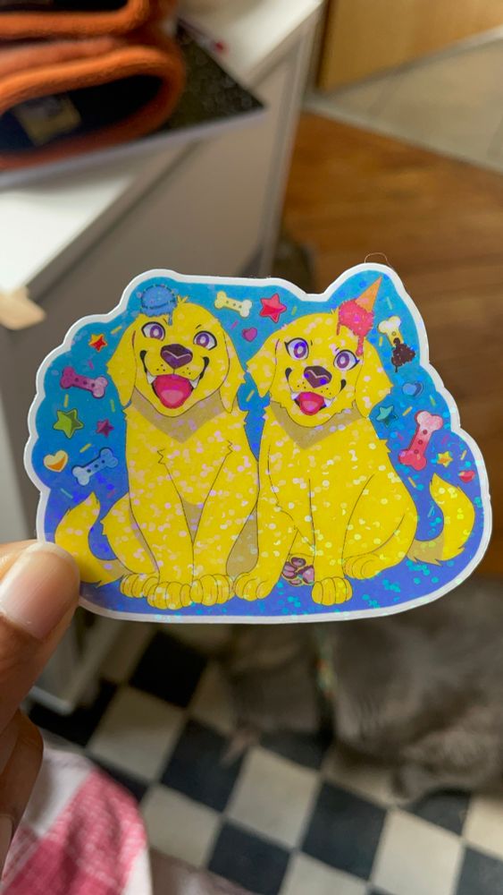 A glittery sticker of the twin treat retrievers.