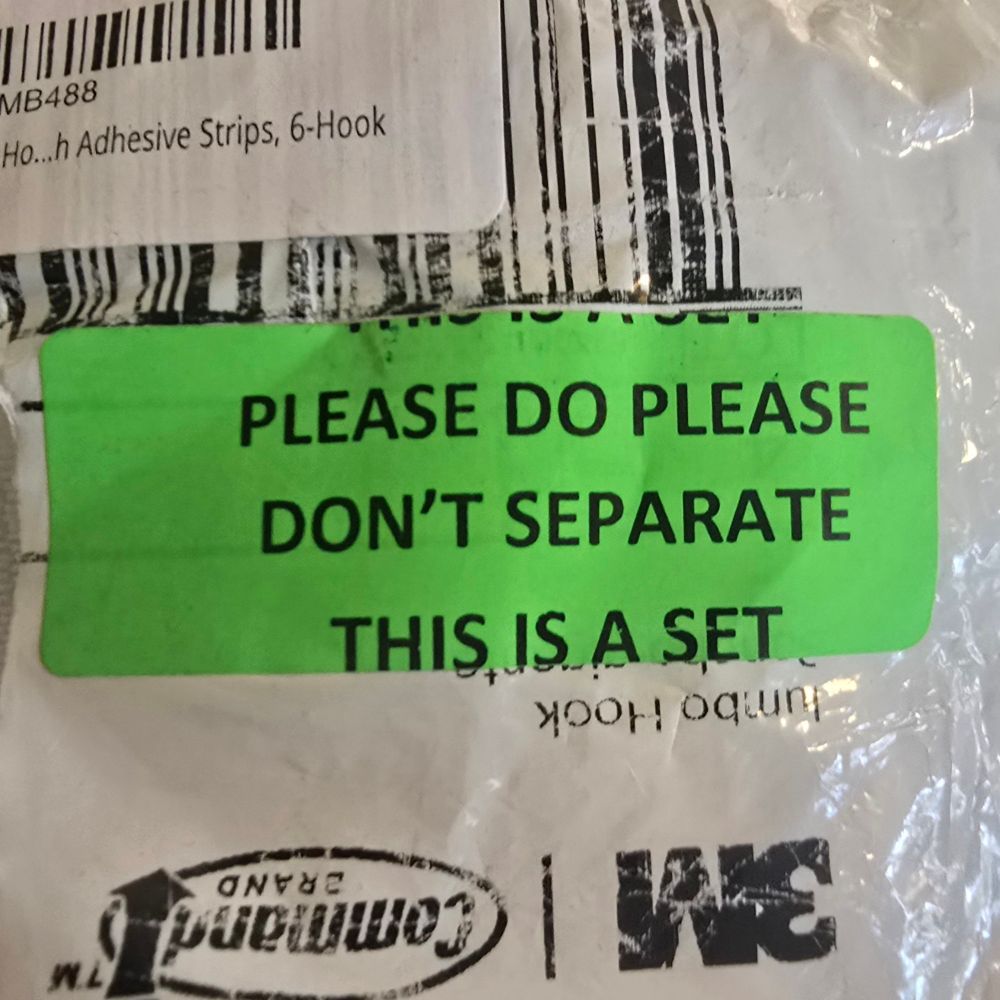 A label on a package of adhesive-backed wall hooks. The label reads "PLEASE DO PLEASE DON'T SEPARATE THIS IS A SET"