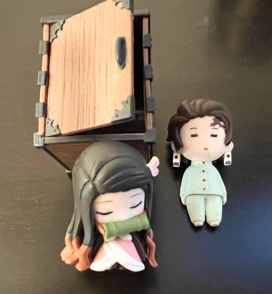 2 small figurines, Nezuko (& her wooden box) and Tanjiro