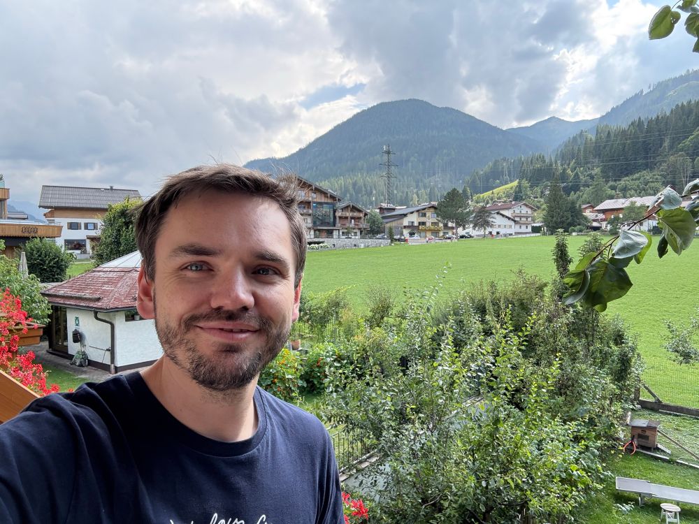 Me with a view of Austrian hills + town in the background