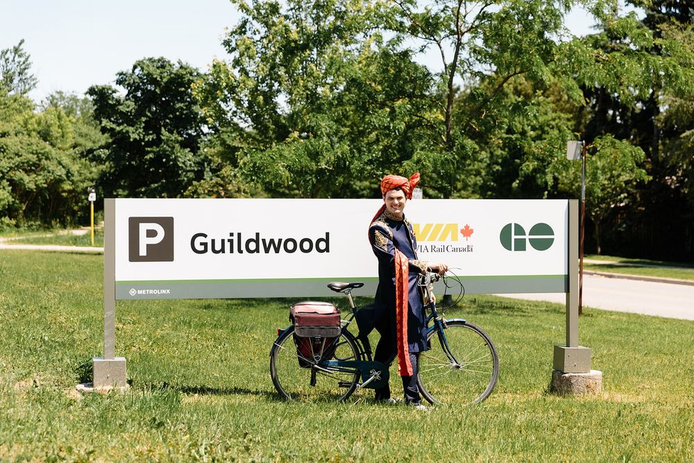 Wedding day in 2019 and standing in front of the Guildwood GO/VIA sign close to the road entrance. 