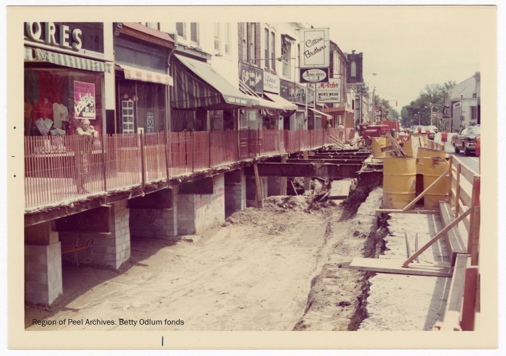 Main St in downtown Brampton looking south in 1970s(?). Beams exposed during construction. Beams apparently due to building over fmr creek. 