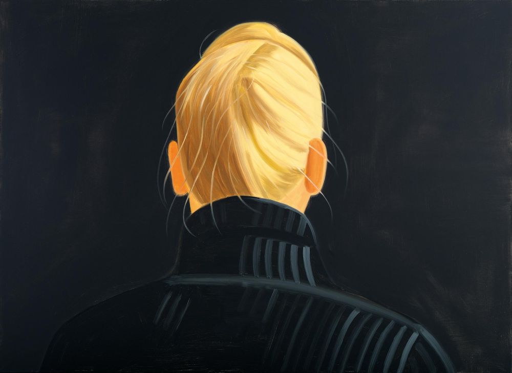 A view from the rear of the head and shoulders of a blonde-haired woman dressed in black and set against a dark background so that only her hair and ears are illuminated.