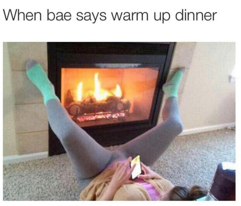 When bae says warm up dinner: woman laying on her back with her legs open either side of a fire