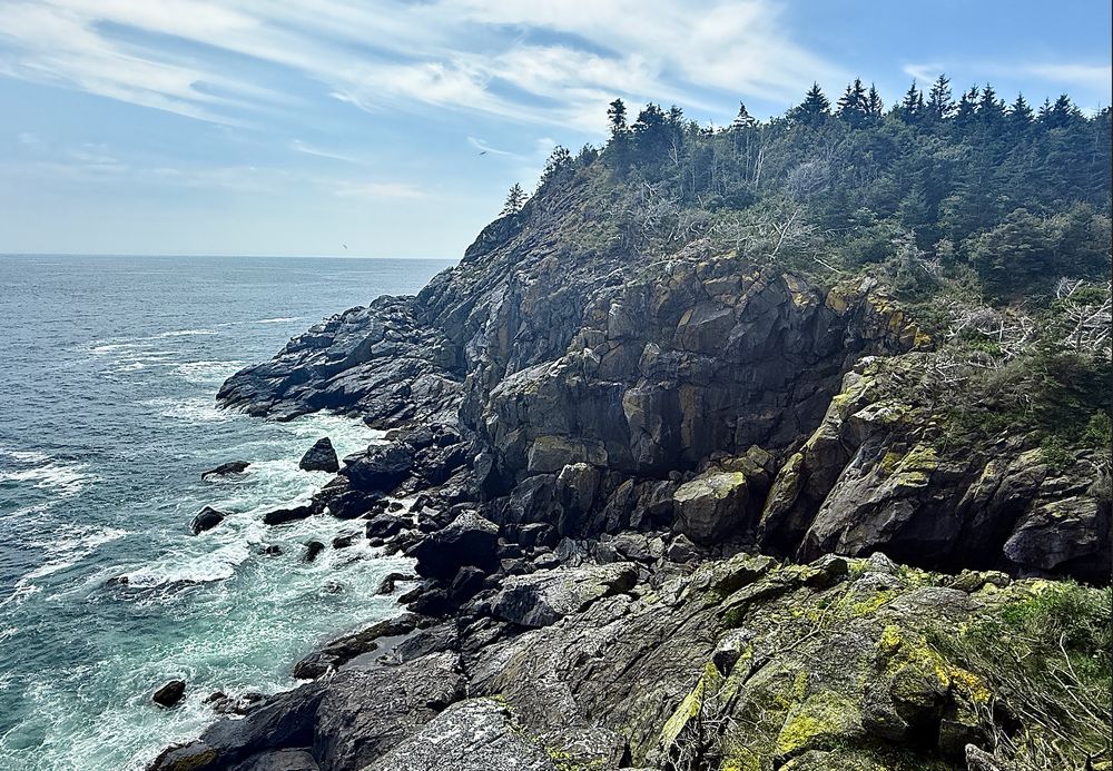 Craggy Maine cliffs overlooking very active waves.
