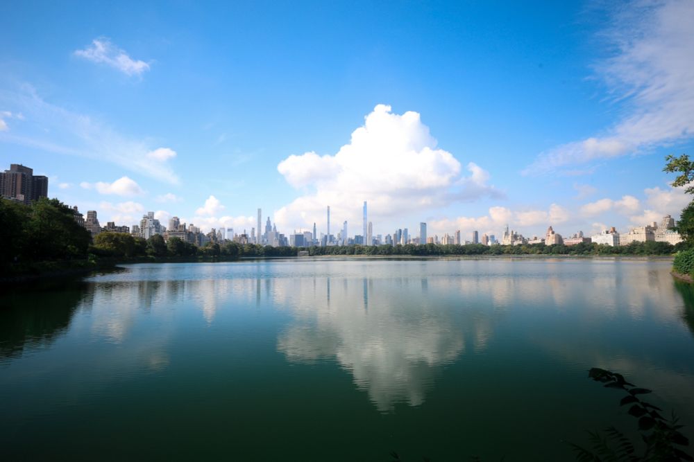 Downtown New York City reflecting on the Jackie Onassis Reservoir