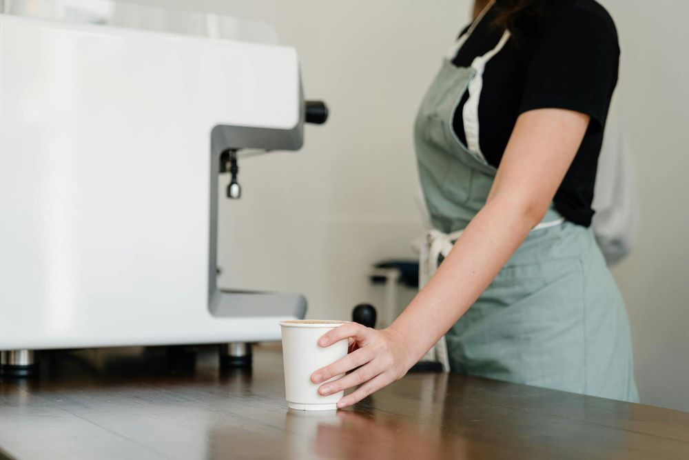 A barista serves coffee.