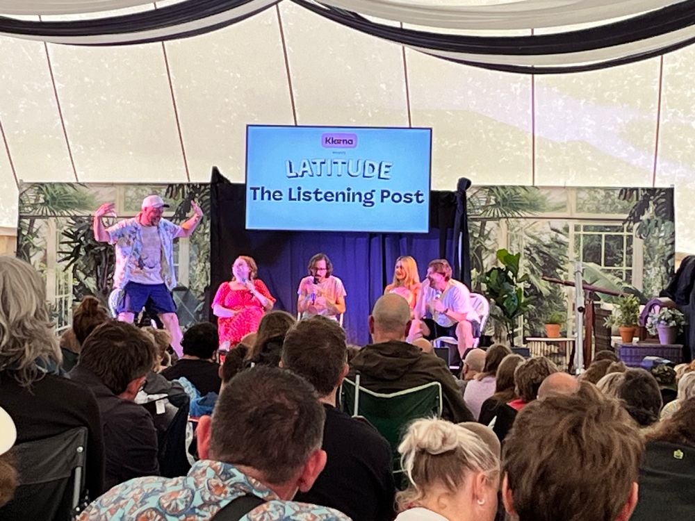 Five comedians on a stage
