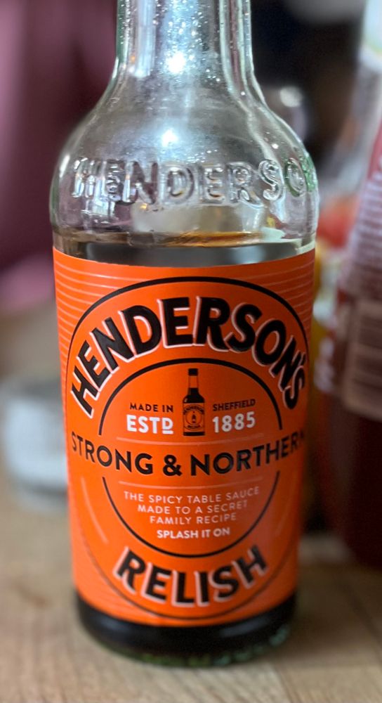 A bottle of Henderson’s Relish with an orange label 