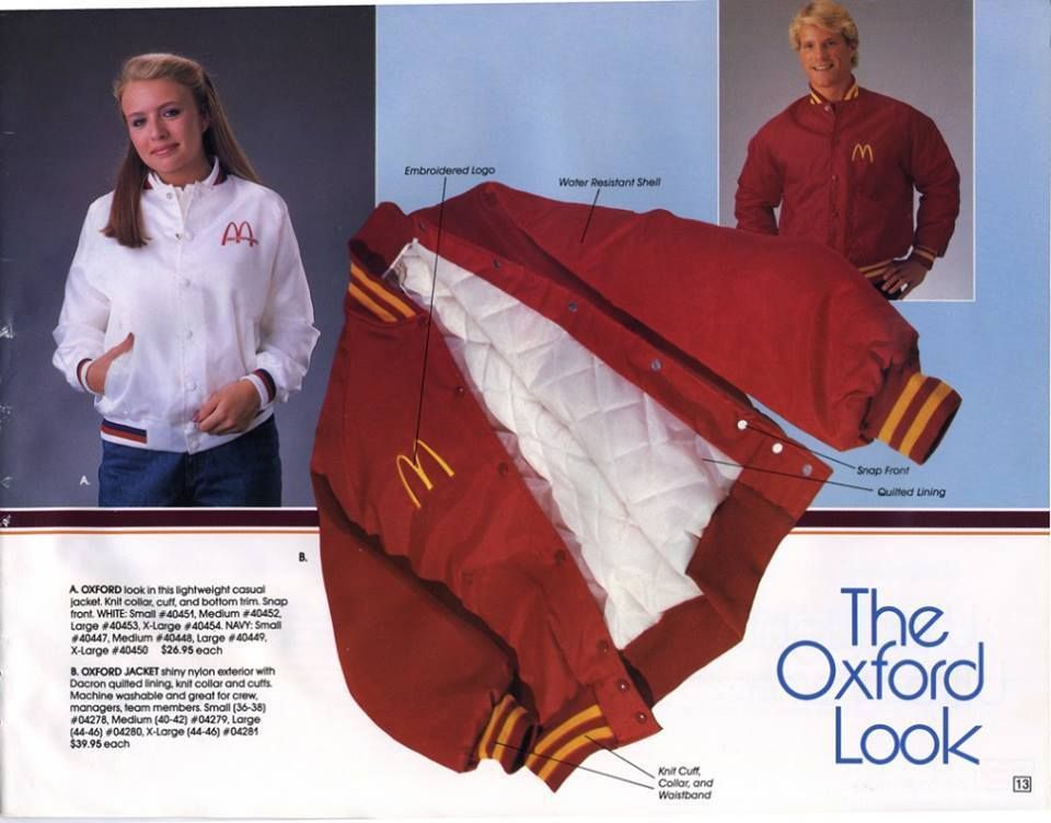 A page from a McDonald's catalog showing "The Oxford Look." Left: A woman in a white McDonald's baseball jacket. Center: A red McDonald's baseball jacket. Right: A man with an 80s haircut wearing a red McDonald's baseball jacket.