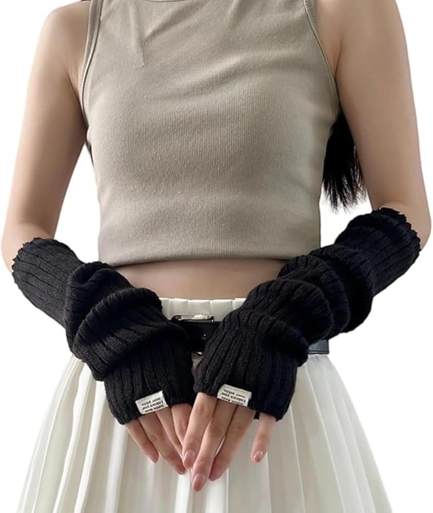 Photography showing a woman with a white top and a white skirt wearing long fingerless black arm warmers