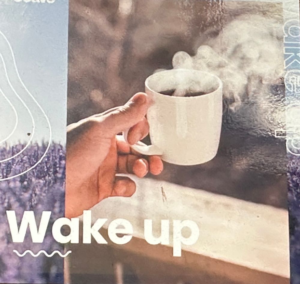 Picture of a Spotify playlist cover. It’s a hand holding a cup of something hot with the title Wake Up.