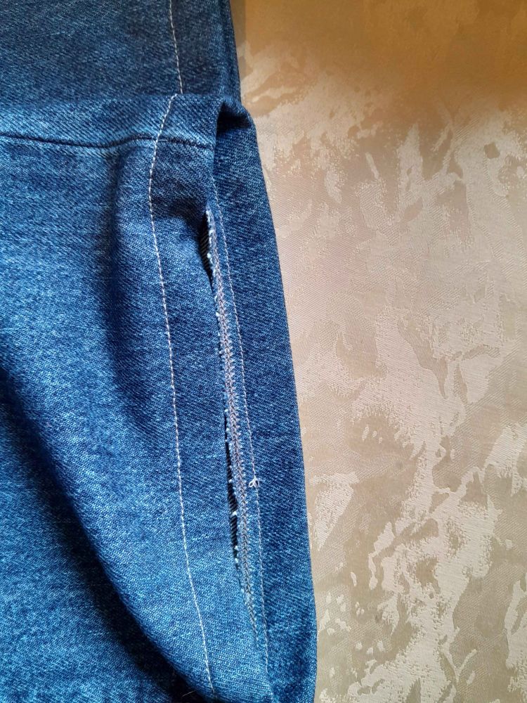The inside of the same hem from the first picture. It's finished with an overlock stitch ironed to the inside and stitched in place with a straight stitch