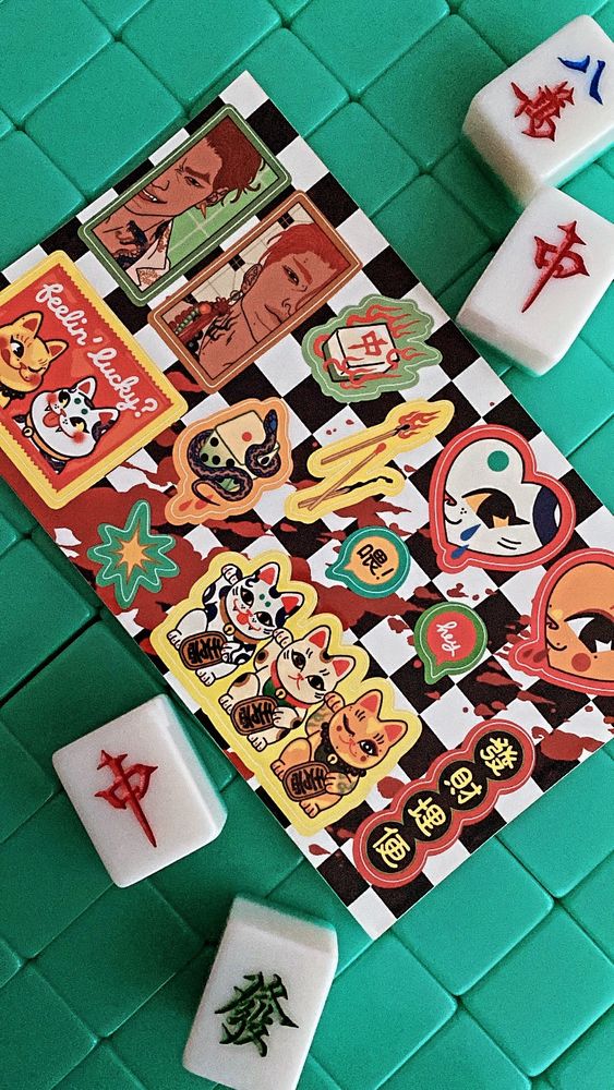 Photo of my sticker sheet of lucky cats with  lucky-and-not-so-lucky items on mahjong tiles 