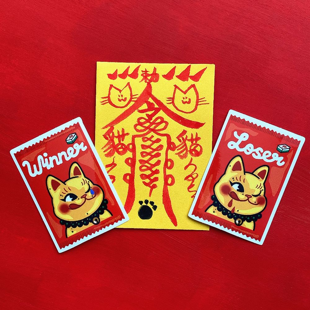 The gold lucky cat gachapon sticker with its new packaging 