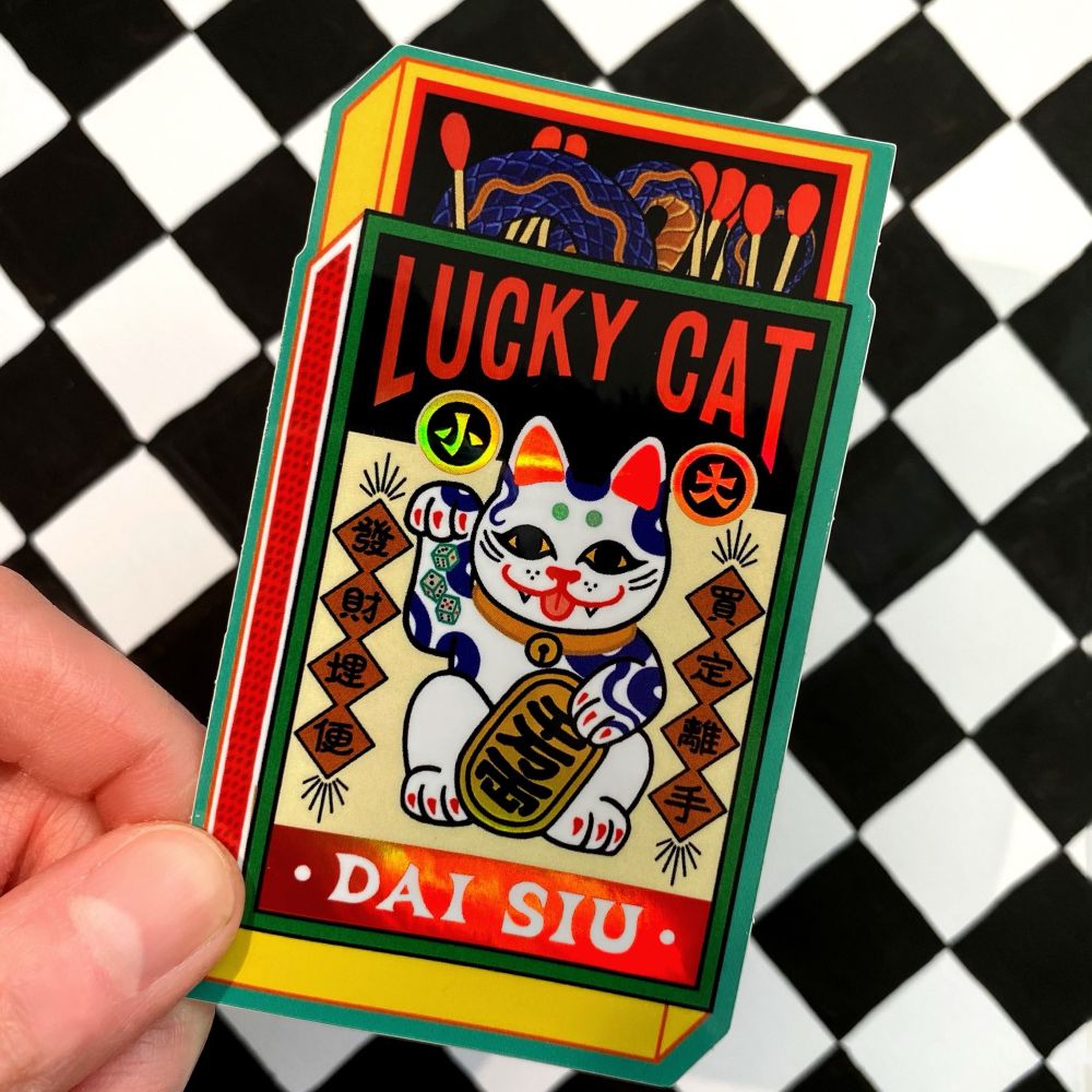 Vintage illustrated matchbox style sticker of a lucky cat 
