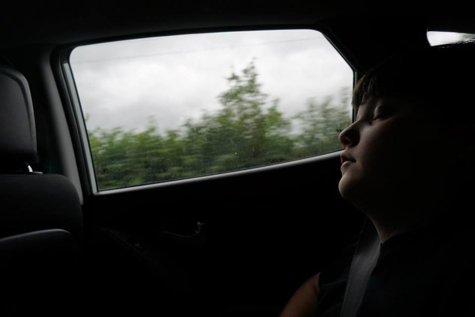 My son sleeping in the back seat of the car