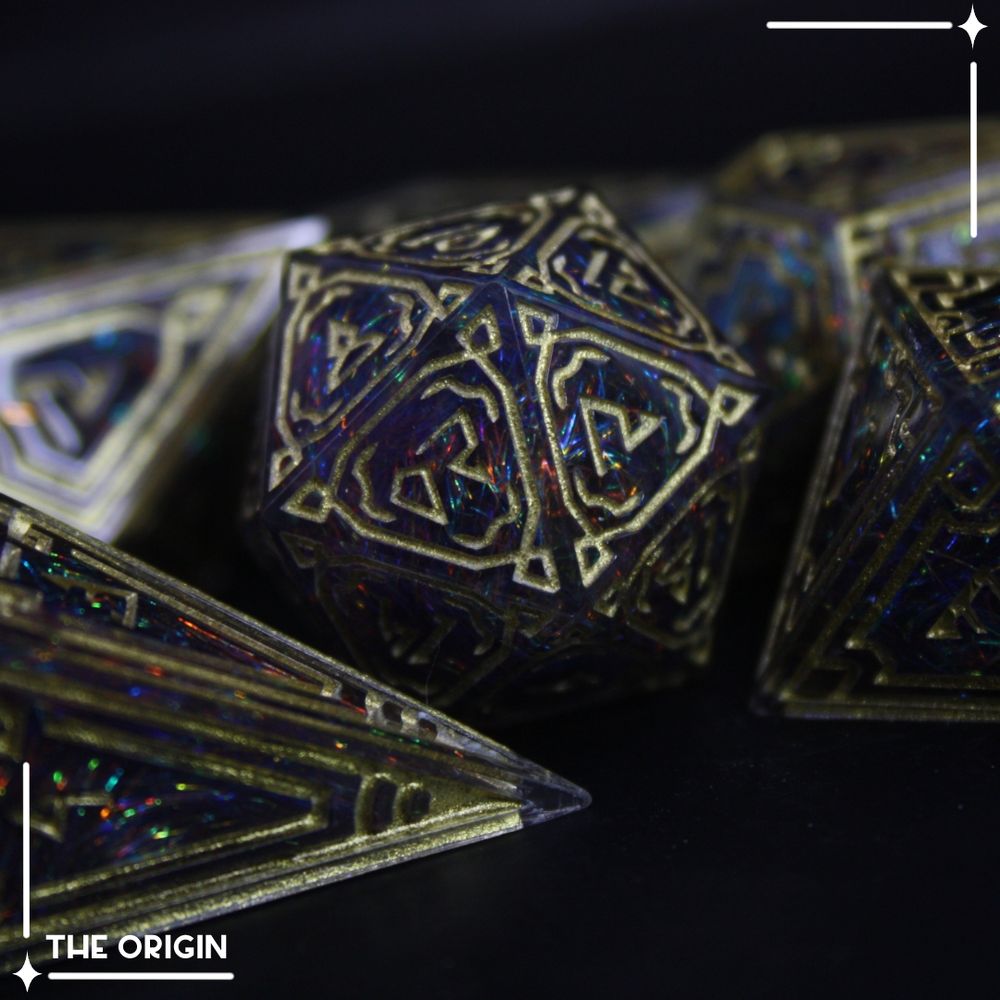 Ornate dice with a dark rainbow inside made with multicoloured fibres, gold patterns and numbers