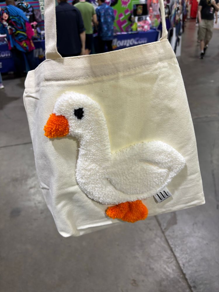 Canvas tote with a white goose made of pulled yarn on it. 