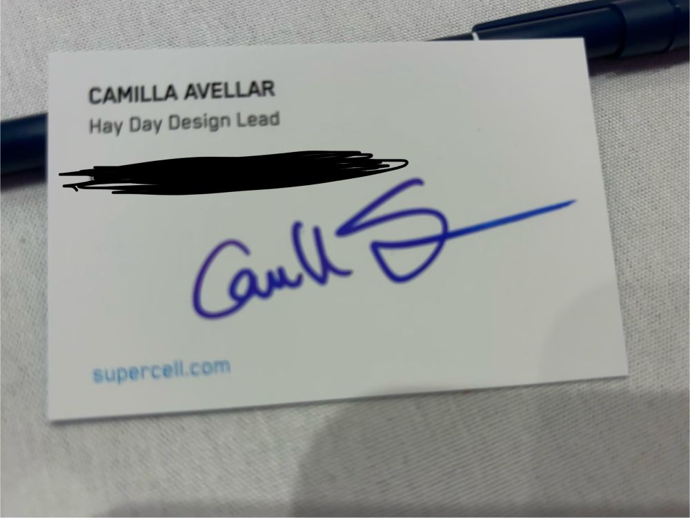 Business card with a signature in blue ink