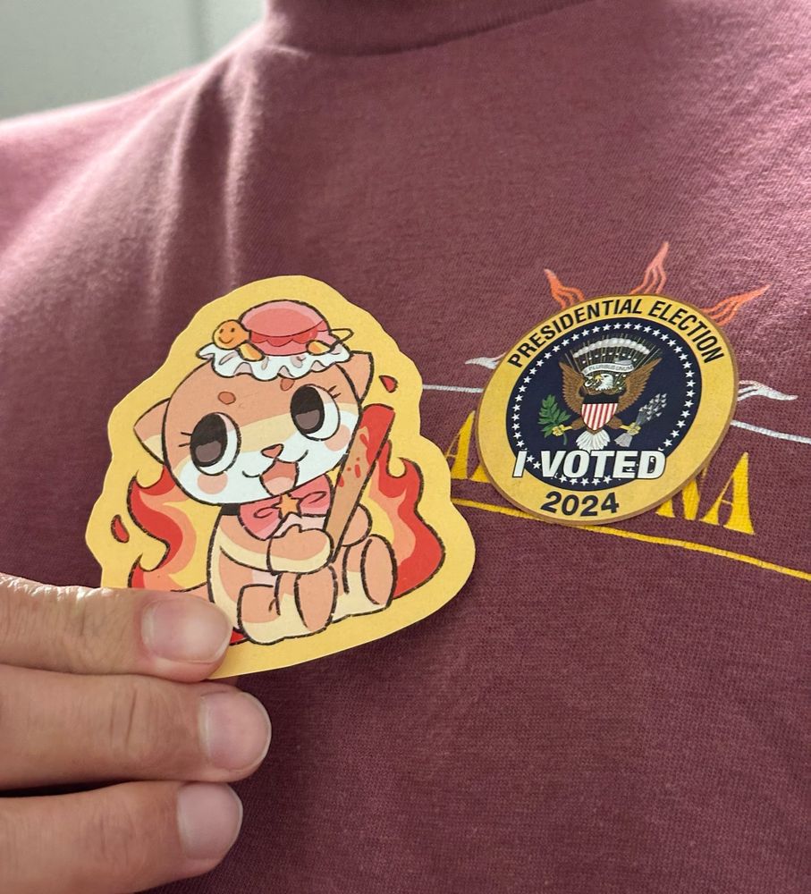 Chiitan burning with a bloody hat sticker (spypie on Etsy) next to Presidential Election I Voted 2024 sticker
