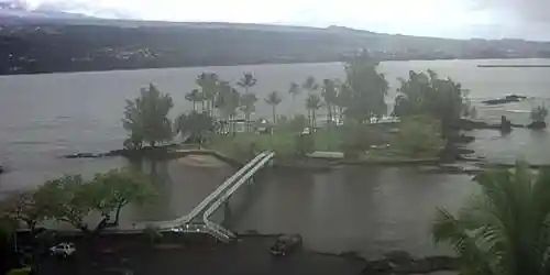 Bridge from parking lot to island

Parking lot not under water