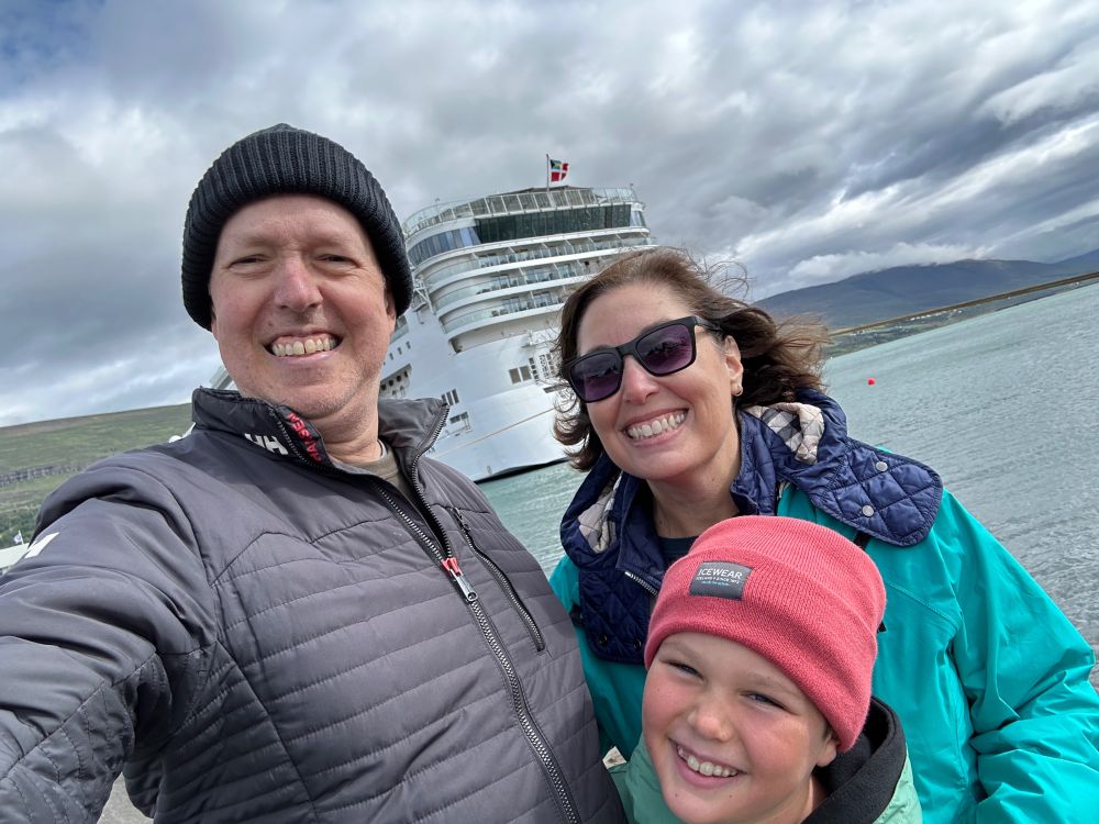 Me, my wife, and my son posing in front of the Norweigan Star cruise ship at port in Iceland.