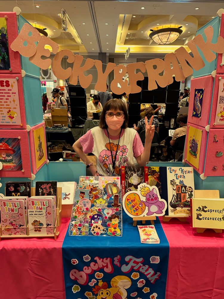 Photograph of Becky Dreistadt at her convention booth at Small Press Expo in North Bethesda, MD
