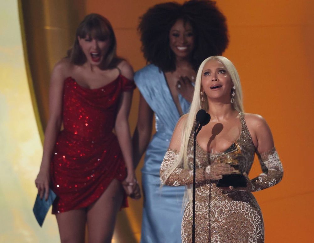 Picture of Beyoncé on stage winning Best Country Album with Taylor Swift behind her - Grammys 2025