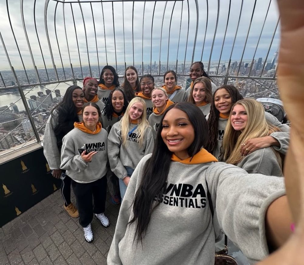 a selfie of the invitees draft classes as the Empire State Building in NYC