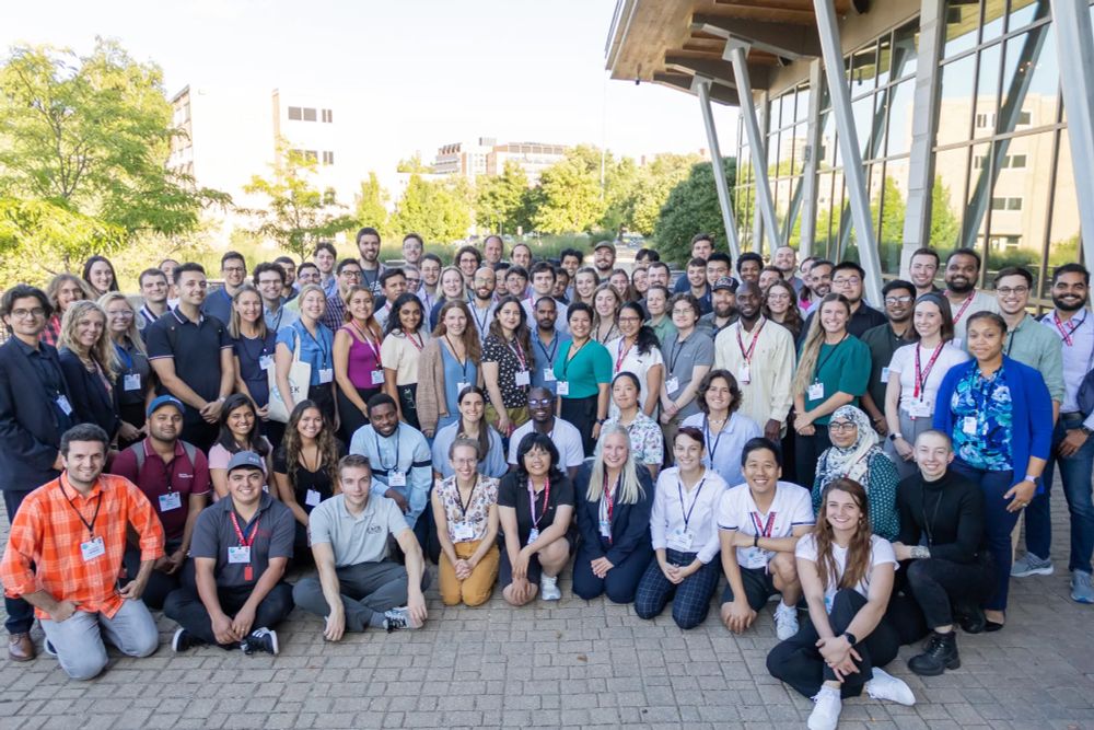 A large, diverse group of coastal engineers and scientists in front of a dining hall at UW-Madison during YCSEC-A 2023.