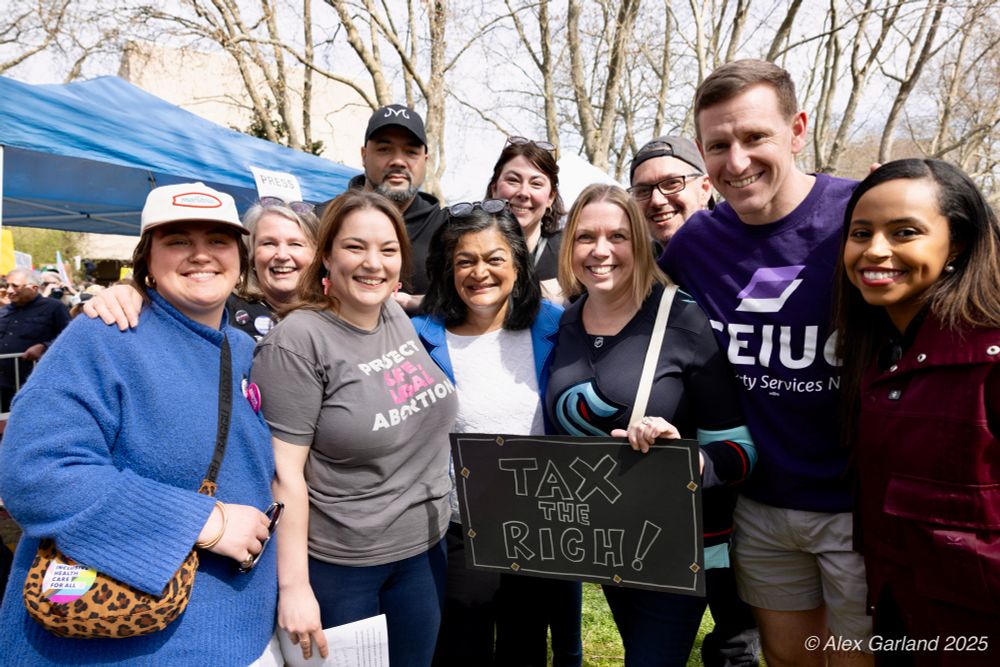 Photo credit to Alex Garland. WA leaders at the Seattle Center Hands Off Rally: Melissa Rubio, Tyna Ek, Madeline Brown, Riall Johnson, Congresswoman Pramila Jayapal, Kayla Ragona, Summer Stinson, Alex Fayer, Port Commissioner Ryan Calkins, Port Commissioner Hamdi Mohamed