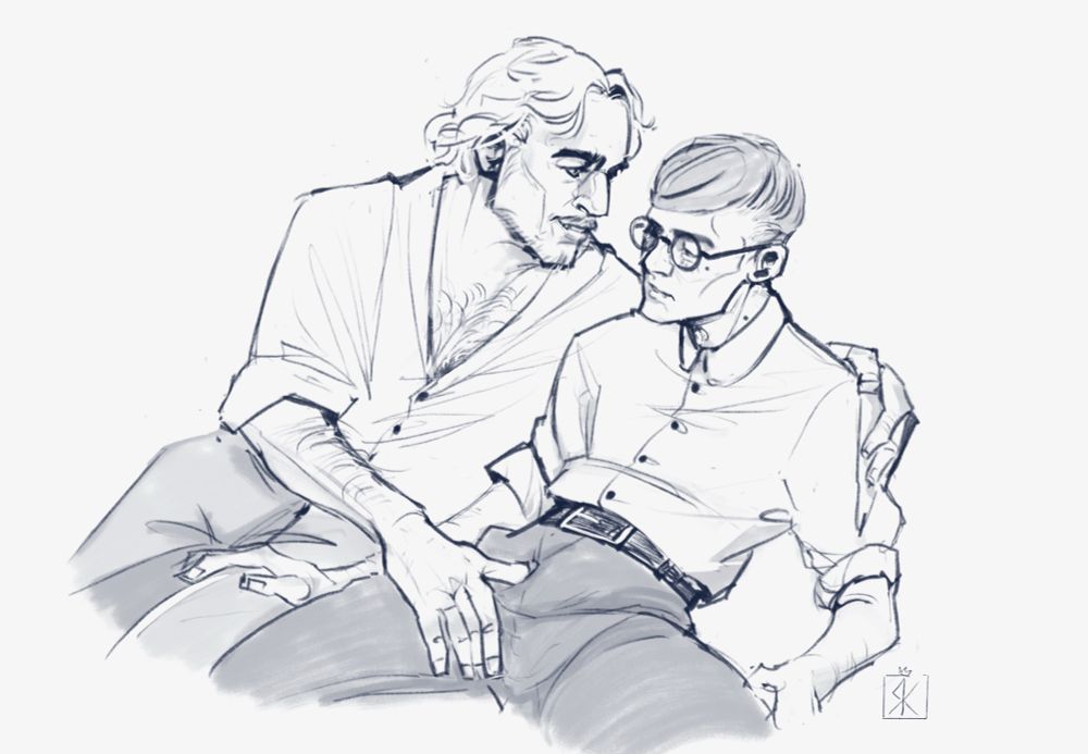 Black and white picture of two men. They sit very close to each other, one hand in the other‘s lap. One smirks, the other is flustered.