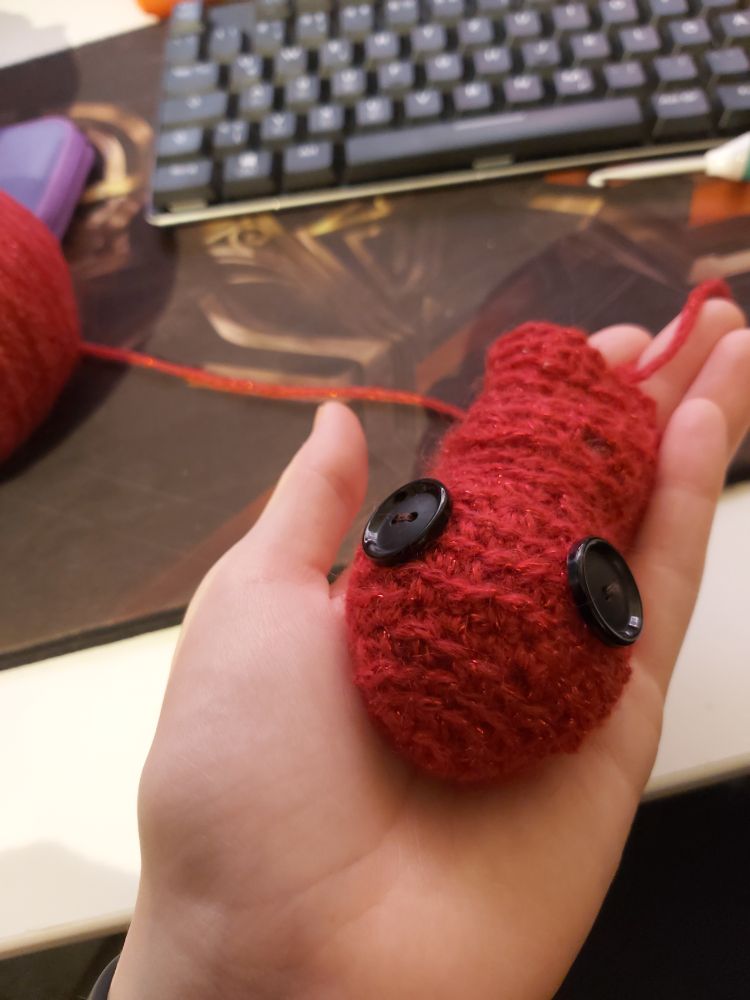 Start of a red crochet snake head. It looks kinda derpy.