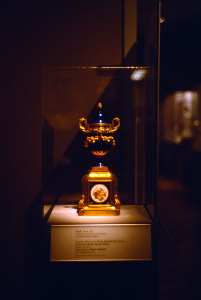 Good and blue clock resembling a Faberge egg in a way, royal blue with brilliant gilded accents.