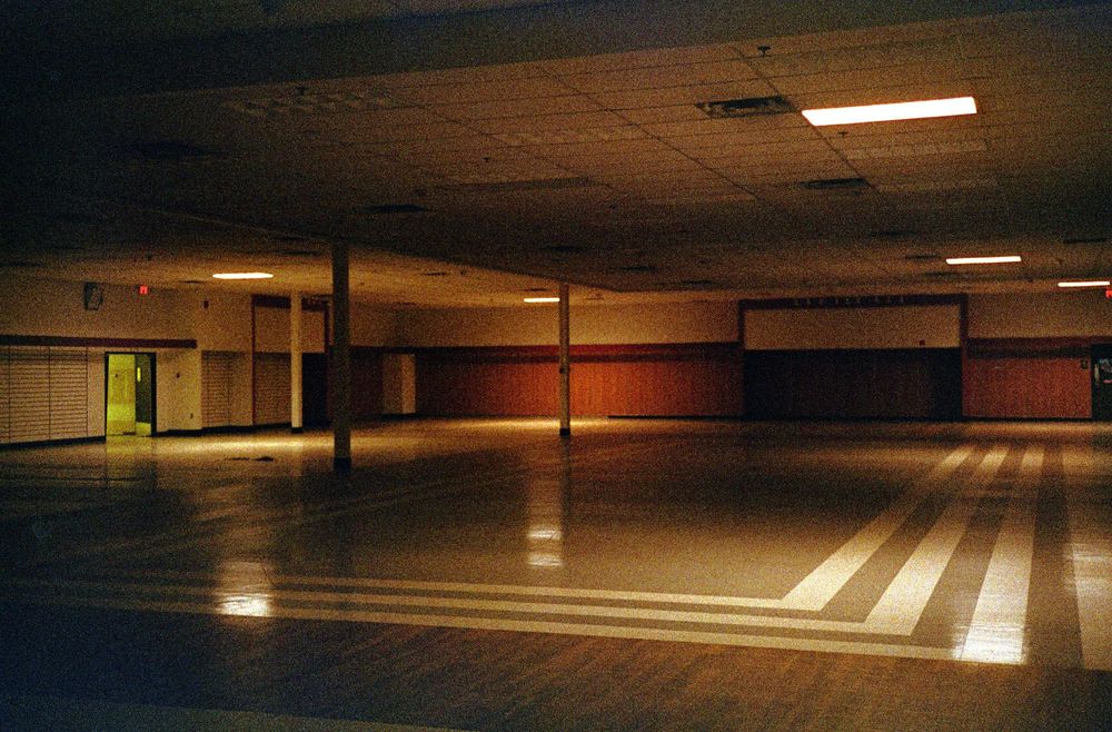 The same as before, angled to the left to show a putrid green florescent glow through an exit door