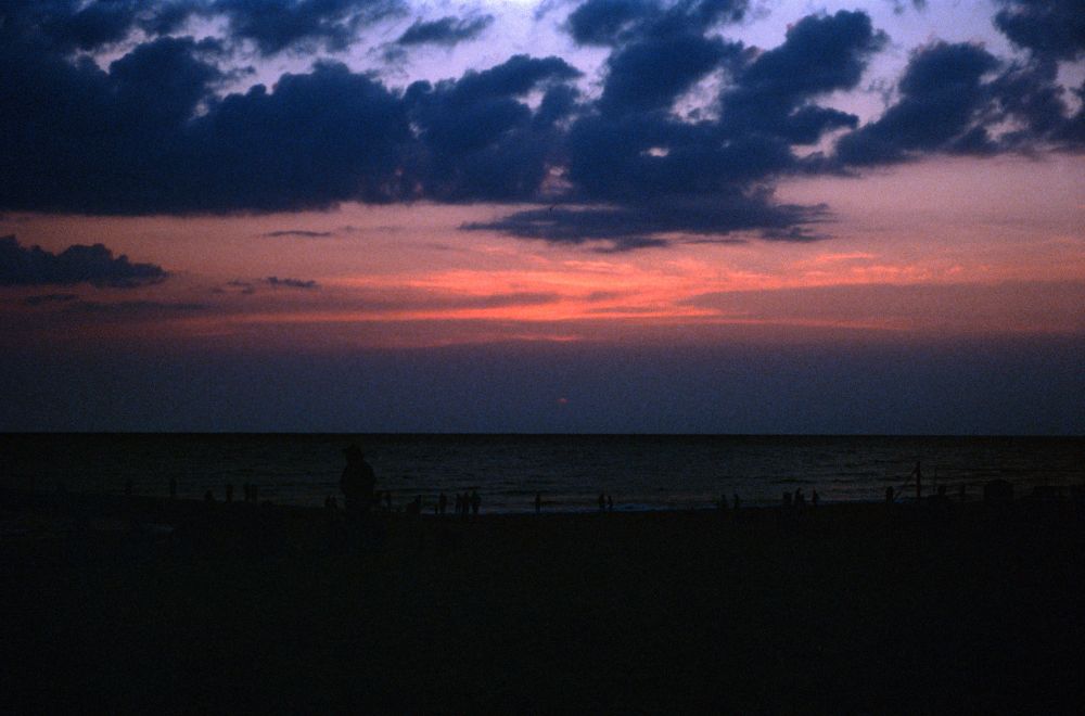 The last moment of the sun being above the horizon, projected and bent through much cloud cover. Beautiful pinks, blues, oranges and purples visible over the lake