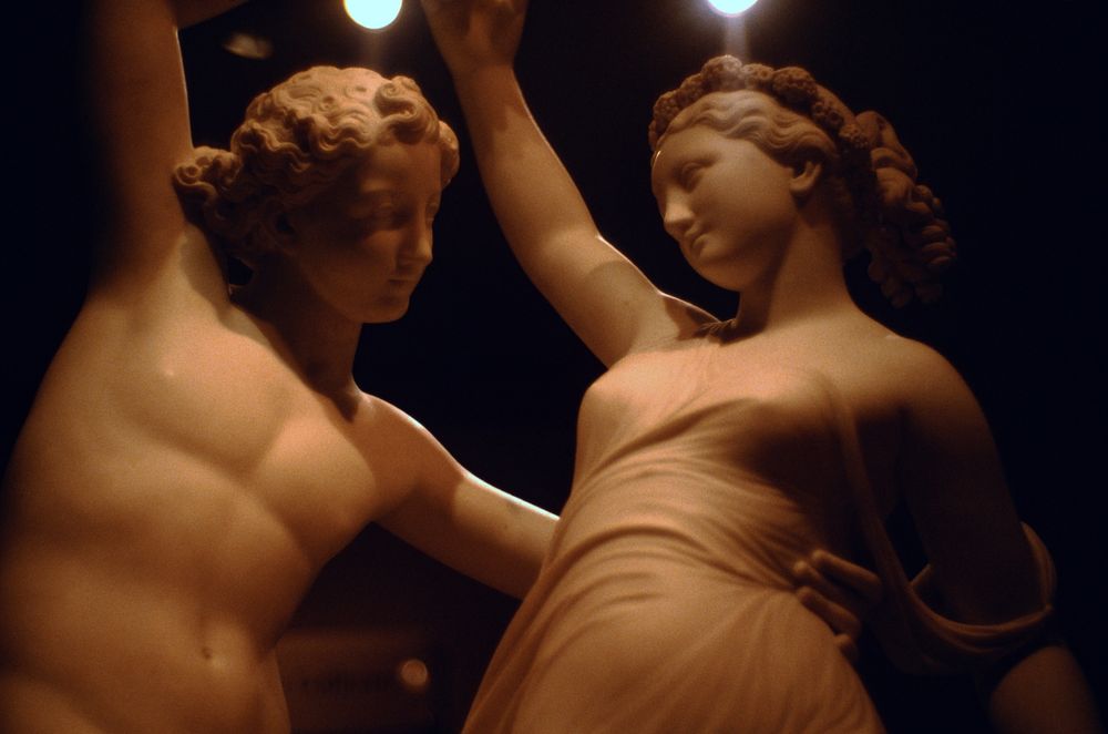 Incredibly detailed marble carvings of a man and woman dancing, the hair detail and draped fabric look almost real