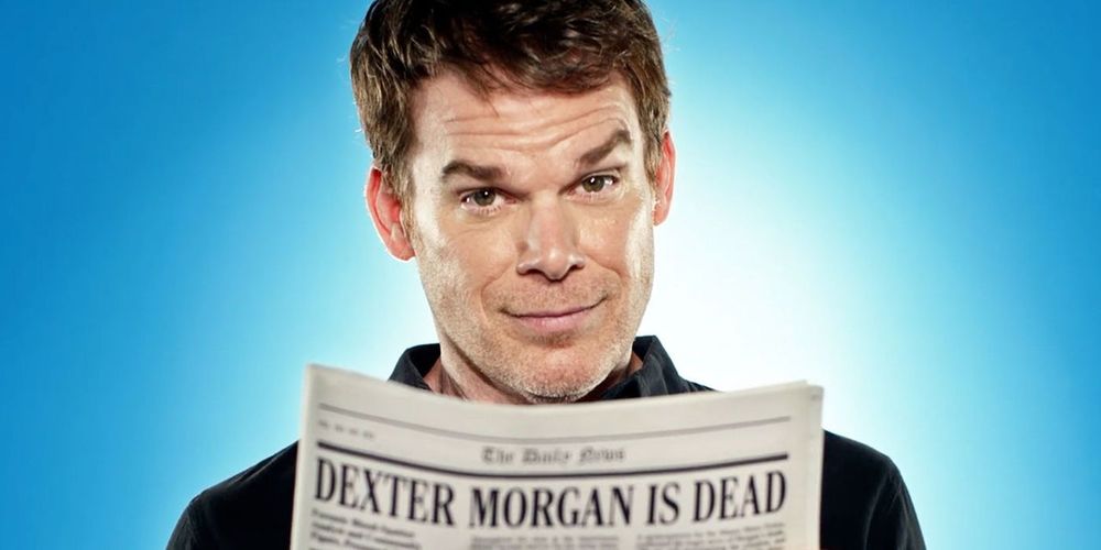 Michael C. Hall as Dexter, a white man with short brown hair.  He has an inquisitive look on his face as he peers over the top of a newspaper with the headline Dexter Morgan Is Dead