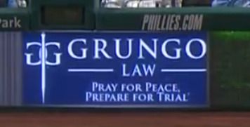 GRUNGO LAW, PRAY FOR PEACE. PREPARE FOR TRIAL. Has a goddamn sword in the logo.