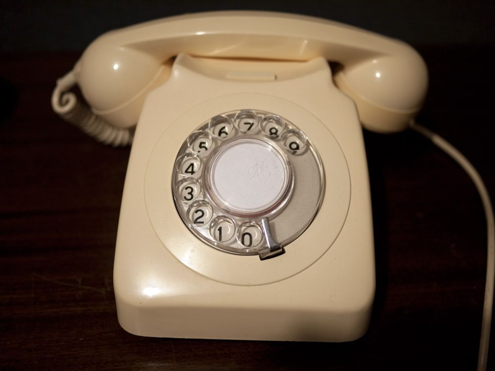 Old cream coloured rotary desk phone, where the numbers on the dial go clockwise 0, 1, 2 ... 9.
In Australia, the numbers went clockwise 0, 9, 8 ... 1 