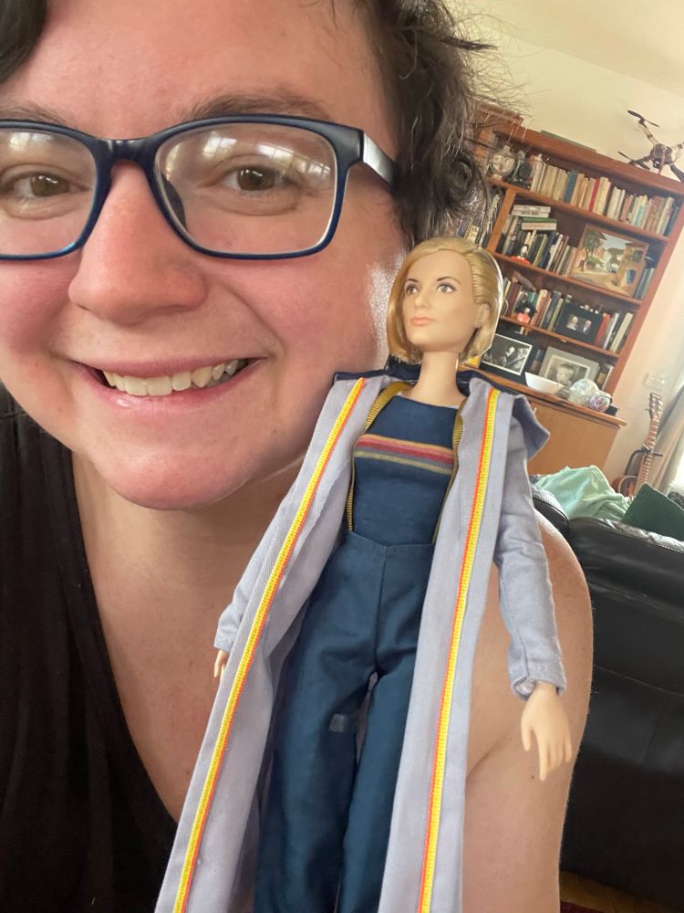 a picture of jamie sapphicsgalaxy with their thirteenth doctor barbie doll